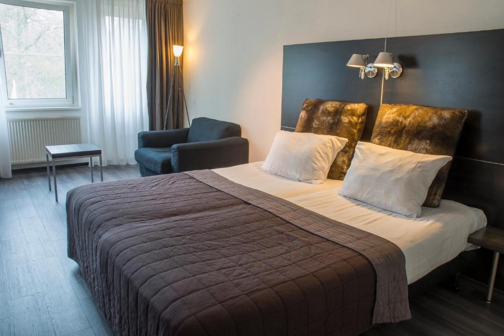 Postel nebo postele na pokoji v ubytování Fletcher Hotel Landgoed Avegoor