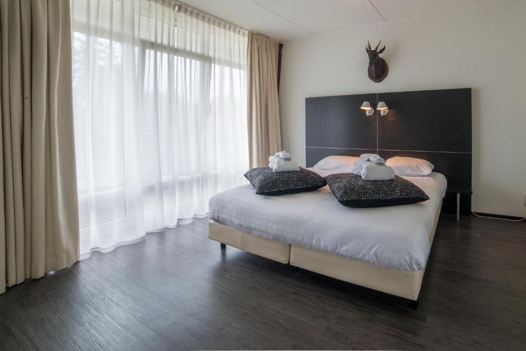 Postel nebo postele na pokoji v ubytování Fletcher Hotel Landgoed Avegoor