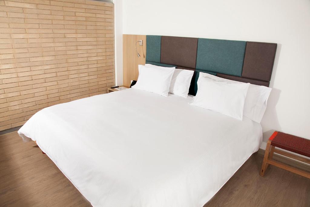 Postel nebo postele na pokoji v ubytování Hotel Viaggio Teleport City Suites