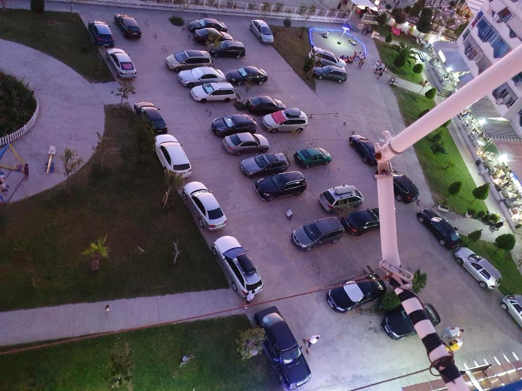 an aerial view of a parking lot with cars at Nada SeaView Apartment in Shëngjin