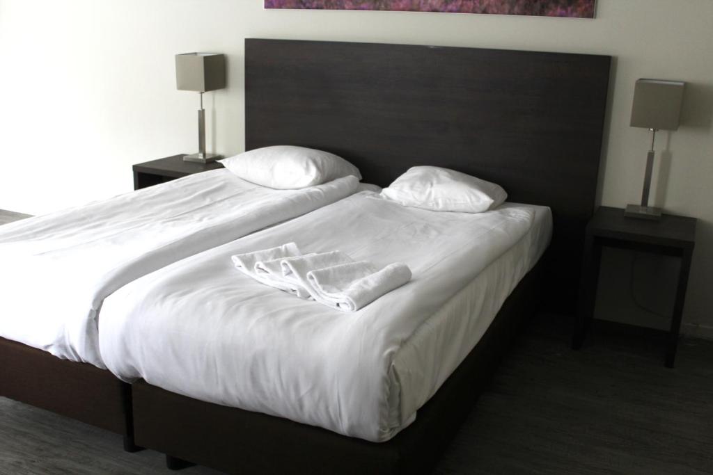 Postel nebo postele na pokoji v ubytování Fletcher Hotel Landgoed Avegoor