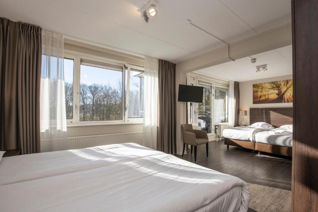 Postel nebo postele na pokoji v ubytování Fletcher Hotel Landgoed Avegoor