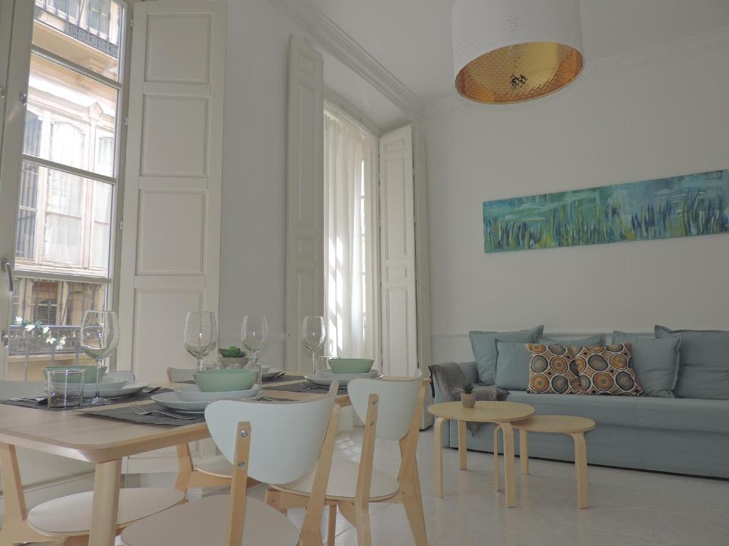 a living room with a table and chairs and a couch at Casita de Santos in Málaga