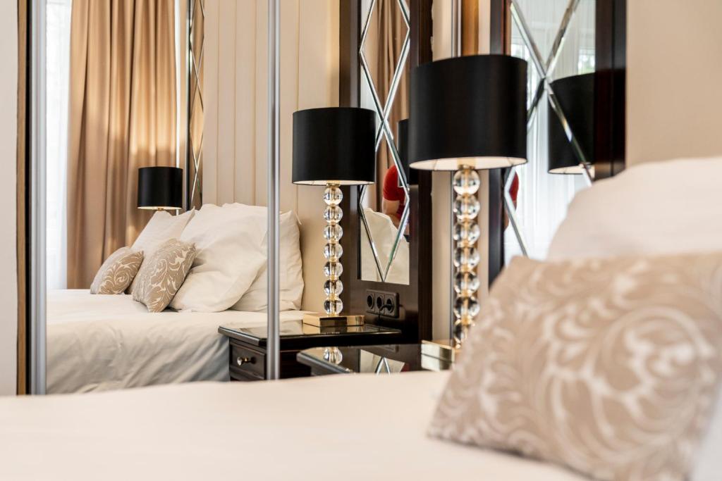 a bedroom with two beds and a mirror at Baltic Beach Hotel & SPA in Jūrmala