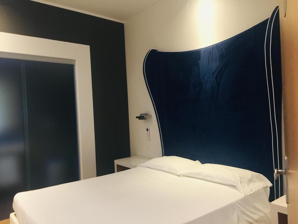 Postel nebo postele na pokoji v ubytování Hotel La Loggia
