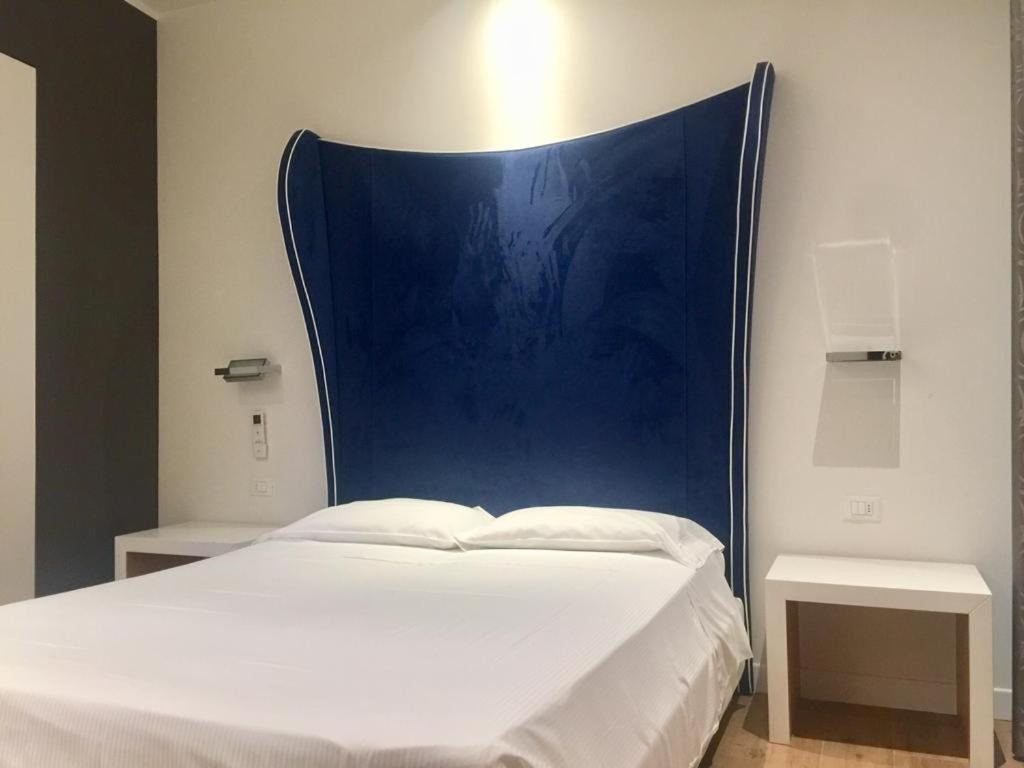Postel nebo postele na pokoji v ubytování Hotel La Loggia