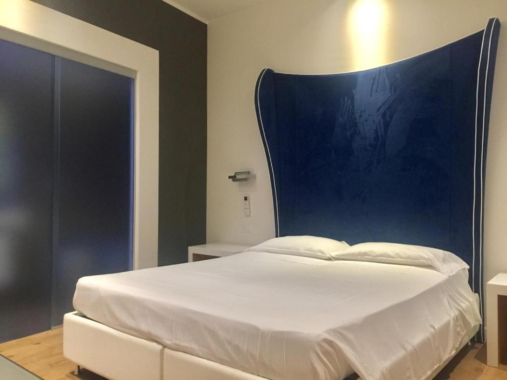 Postel nebo postele na pokoji v ubytování Hotel La Loggia