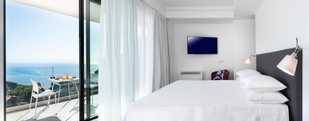 A bed or beds in a room at The View Luxury Apartments Taormina
