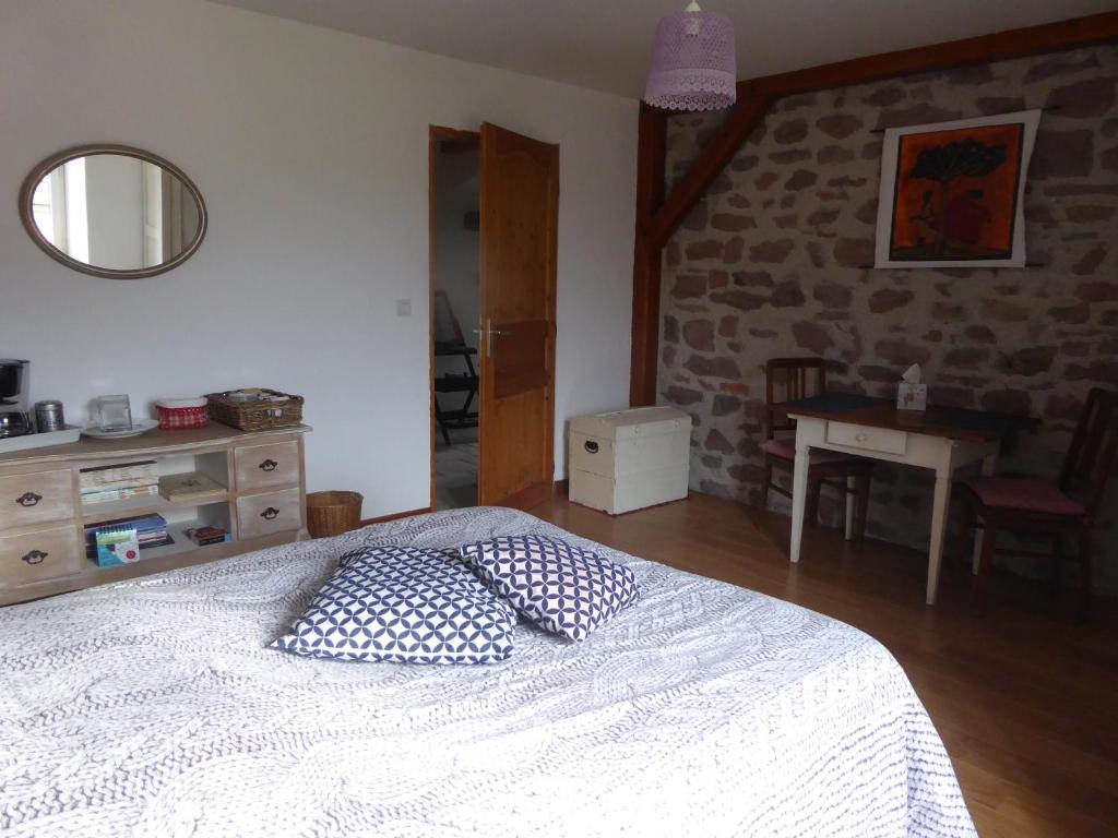 a bedroom with a bed with two pillows on it at La Chambre de Manon in Saint-Maurice