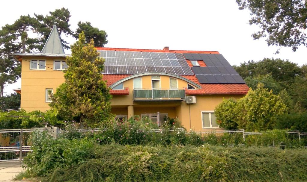 a house with solar panels on its roof at Lívia Apartman in Balatonfüred