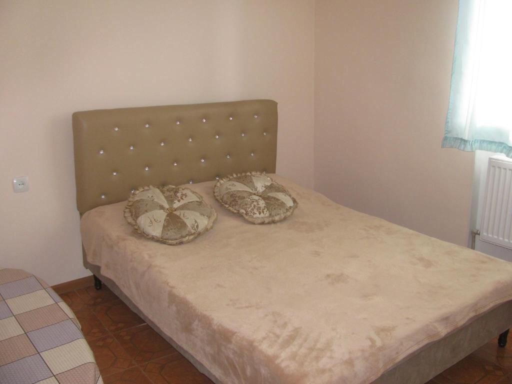 a bed with two pillows on it in a room at Ani Guest House in Tsaghkadzor