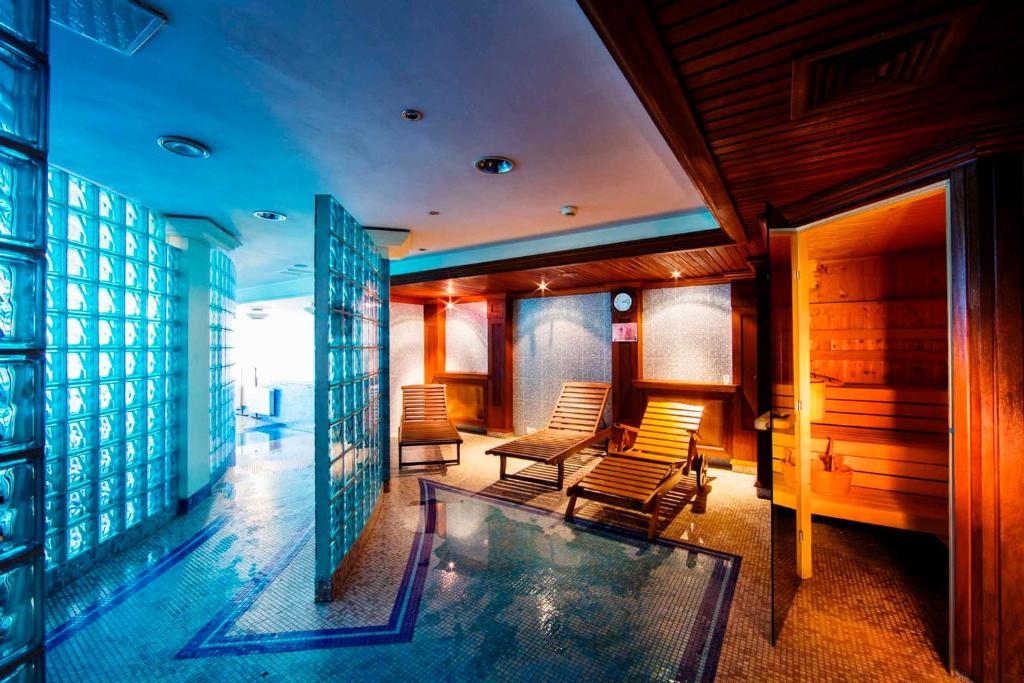 a room with chairs and a swimming pool at Haffner Hotel & SPA Sopot - Destigo Hotels in Sopot