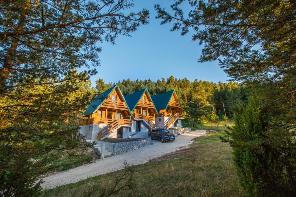 a log home with a blue roof at Paradise Zabljak in Žabljak