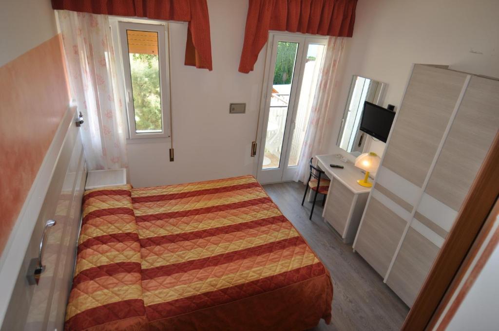 Postel nebo postele na pokoji v ubytování Hotel Righetto Fronte Mare
