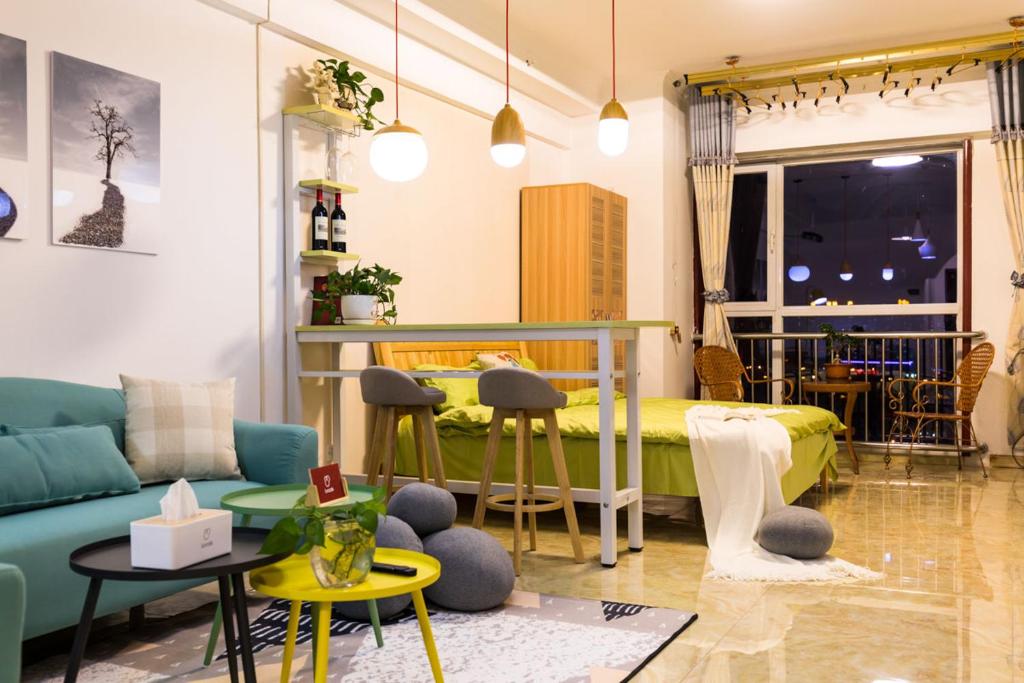 a living room with a couch and a bed at XiNing Chengxi ·Wanda square· in Xining