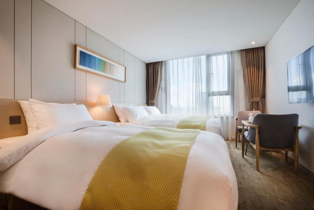 Postel nebo postele na pokoji v ubytování Hotel Winstory