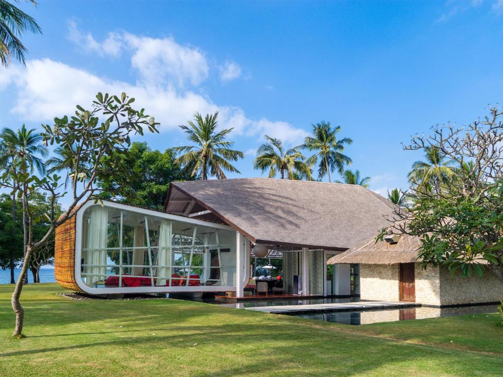 a house with a large window on the side of it at Villa Sapi by Elite Havens in Tanjung