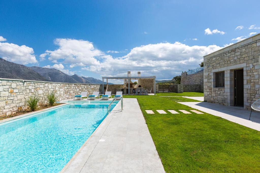a swimming pool in the backyard of a house at Thalmargia Villas, Ultimate Peace & Privacy, By ThinkVilla in Rethymno
