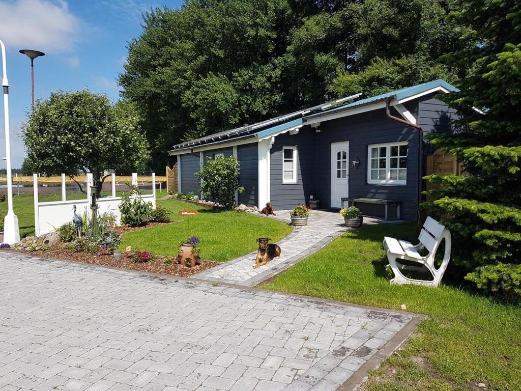 a house with two dogs sitting in the yard at Ferienhaus Fröhlich in Ladelund