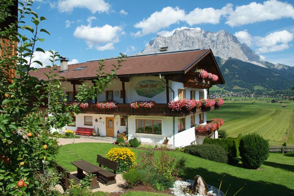 a house with a mountain in the background at Pension Bartlhof in Lermoos