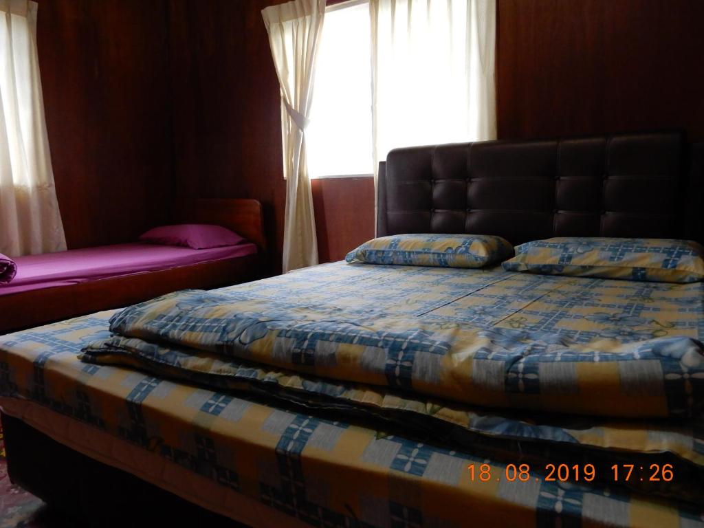 Postel nebo postele na pokoji v ubytování Bulan And Daud Homestay