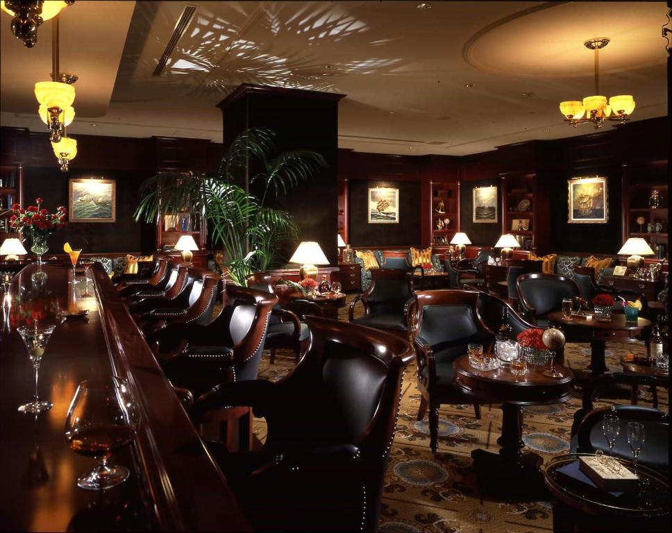 a bar with chairs and tables in a restaurant at Nagoya Marriott Associa Hotel in Nagoya