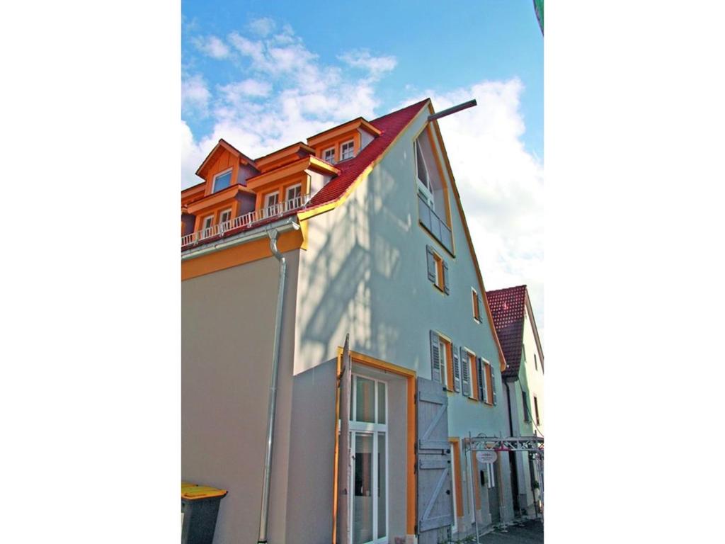 a white building with a red roof at Villa Arena in Geisingen