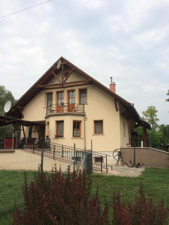 a large white house with a gambrel roof at Cosy rooms on the lake near Budapest and the Airport in Isaszeg