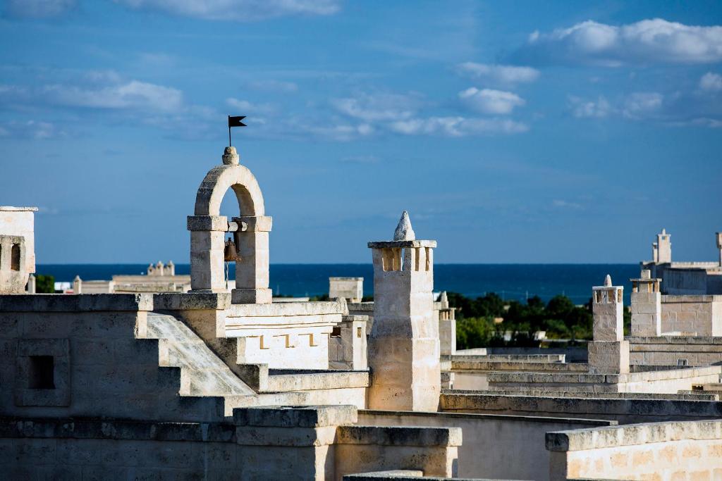 a building with a flag on top of it at Borgo Egnazia in Savelletri di Fasano