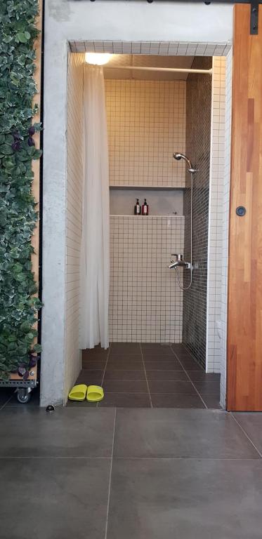 a bathroom with a shower with a shower curtain at Taitung Jia Lulan Tribal in Taitung City
