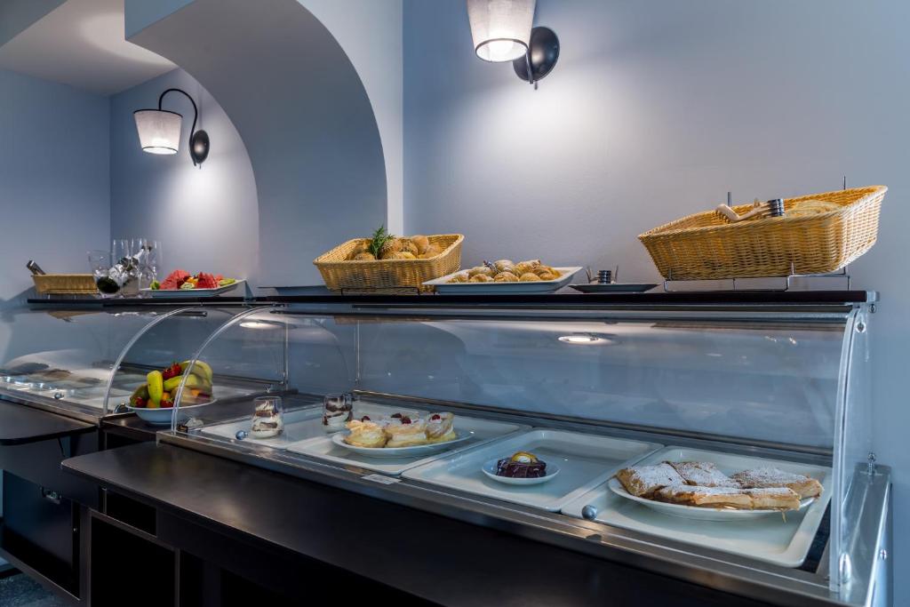 a buffet line with different types of food on plates at Hotel Domino in Opatija