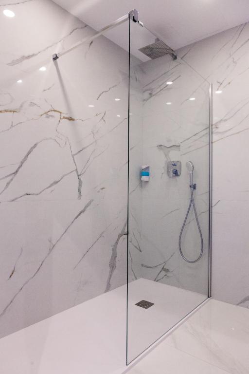 a shower with a glass door in a bathroom at Los Arcos in Nerja