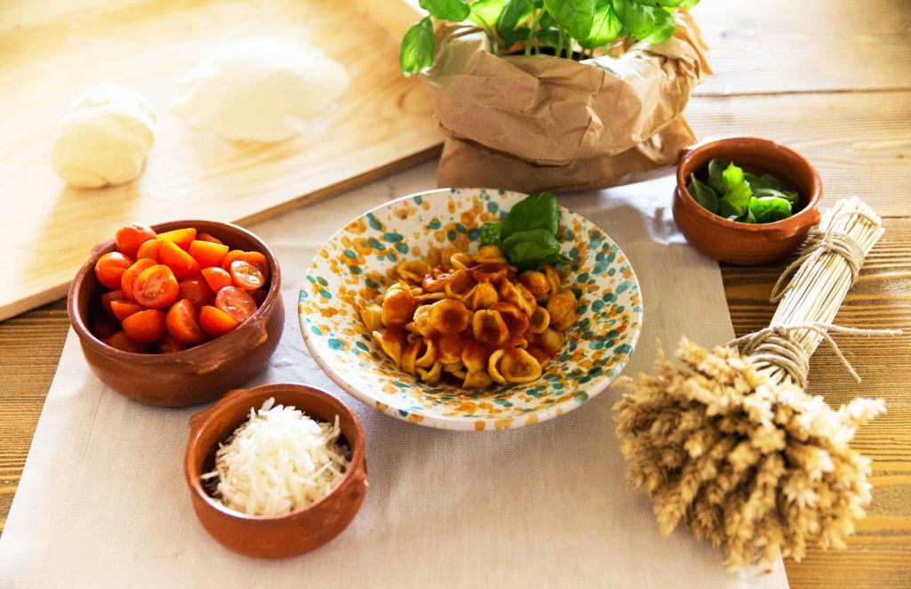 a table with a bowl of food and bowls of rice at Borgo Egnazia in Savelletri di Fasano