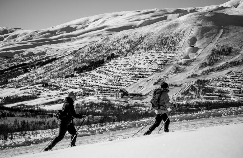 two people skiing down a snow covered mountain at Myrkdalen Resort Hotel in Myrkdalen