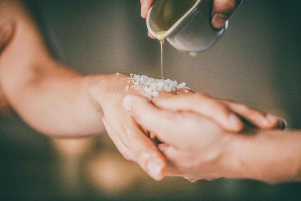 a person is holding a hand with sand on it at Borgo Egnazia in Savelletri di Fasano