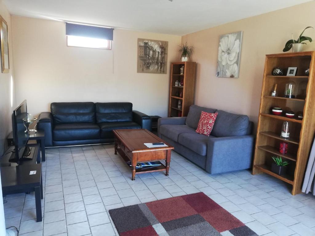 a living room with two couches and a coffee table at Marielu in Pouilly-sur-Loire