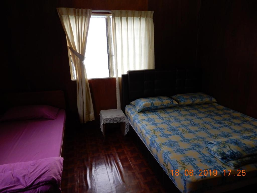 Postel nebo postele na pokoji v ubytování Bulan And Daud Homestay