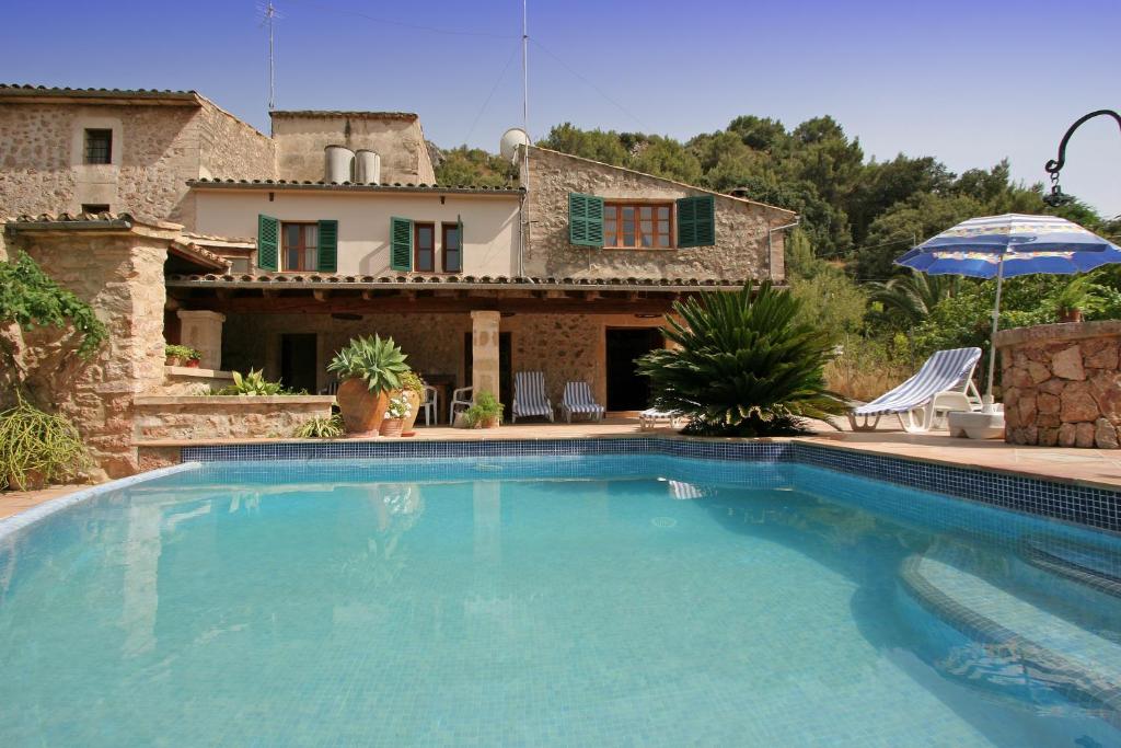 a swimming pool in front of a house at Villa Camp Redo in Pollença
