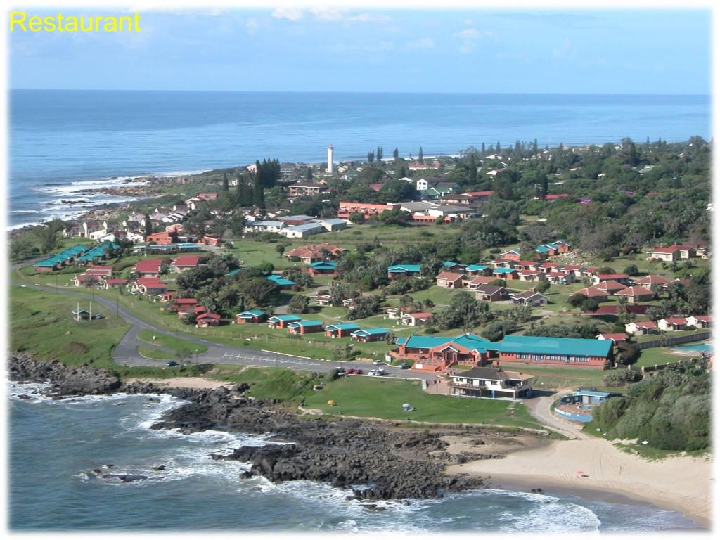 an aerial view of a town next to the ocean at Port Edward Holiday Resort in Port Edward