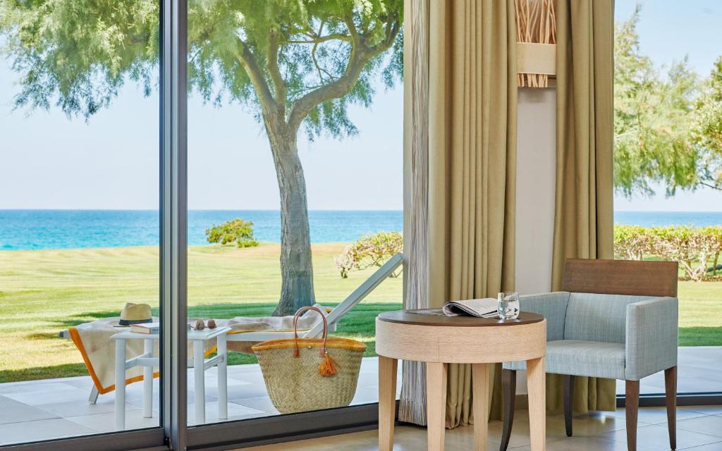 a living room with a view of the ocean at Capovaticano Resort Thalasso Spa in Capo Vaticano