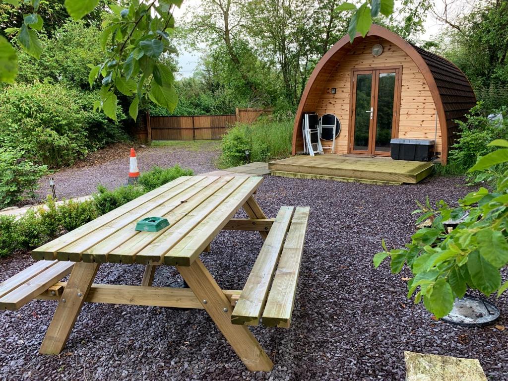 a picnic table in front of a small tent at Tig Lammax in Macroom