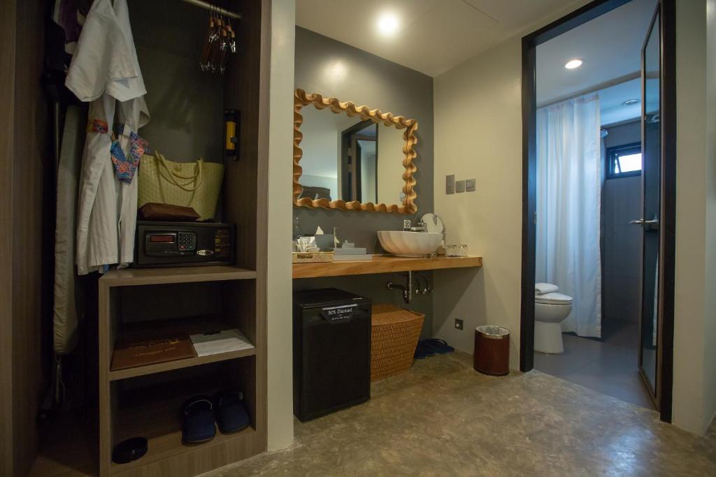 a bathroom with a sink and a mirror at Deevana Krabi Resort in Ao Nang Beach