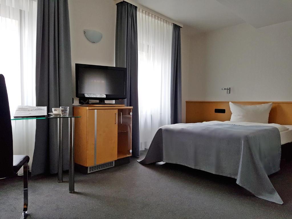 Postel nebo postele na pokoji v ubytování Hotel Ross