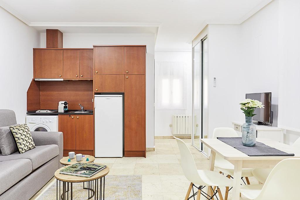 a kitchen and living room with a couch and a table at LEEWAYS LOFT XXXI in GRAN VÍA in Madrid