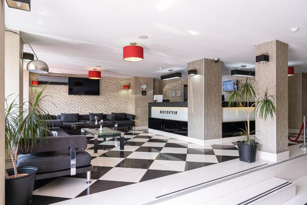 a lobby with black and white checkered floor at Hotel Parliament in Bucharest