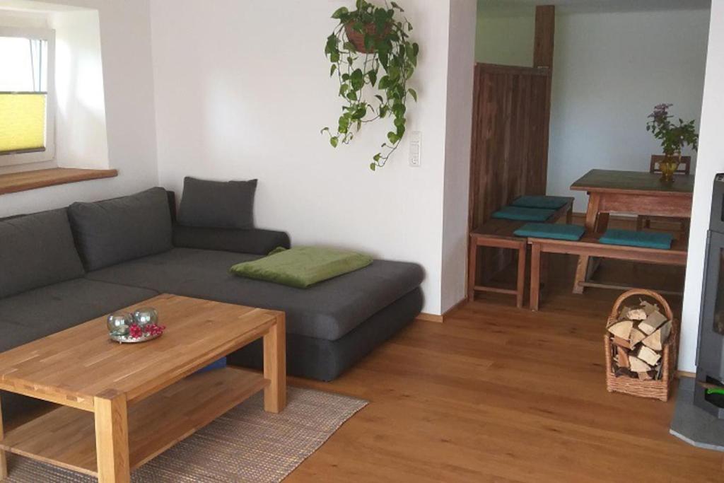 a living room with a couch and a coffee table at Ferienwohnung Bäckerberg in Scharnstein