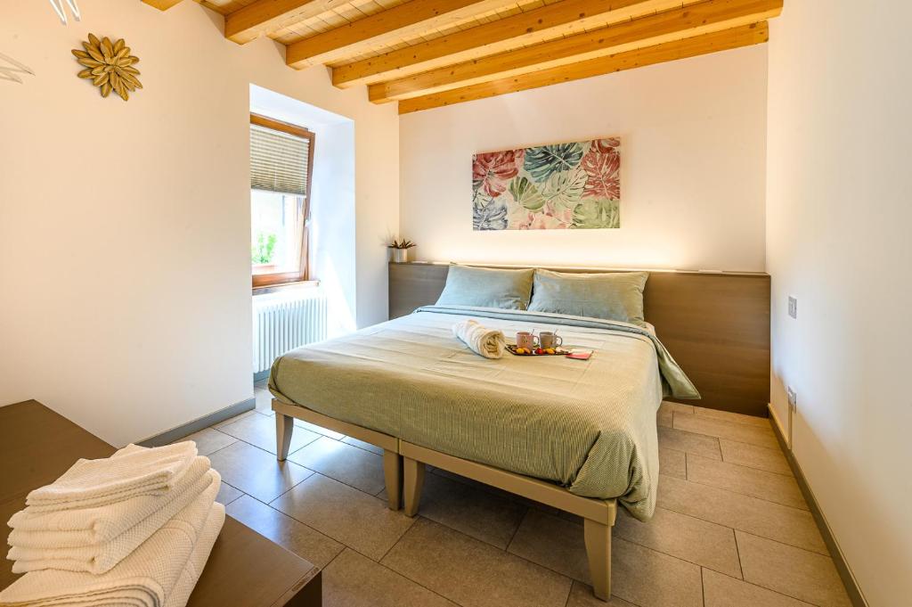 a bedroom with a bed with a tray of food on it at Old Town Apartments in Tirano