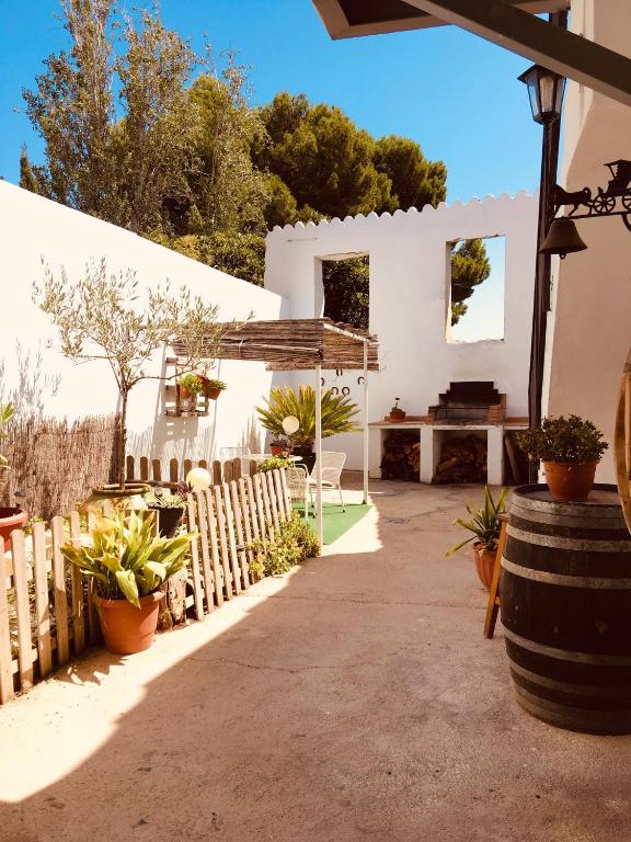 a patio with a wooden fence and a bench at La casita Santa Bárbara in Macastre
