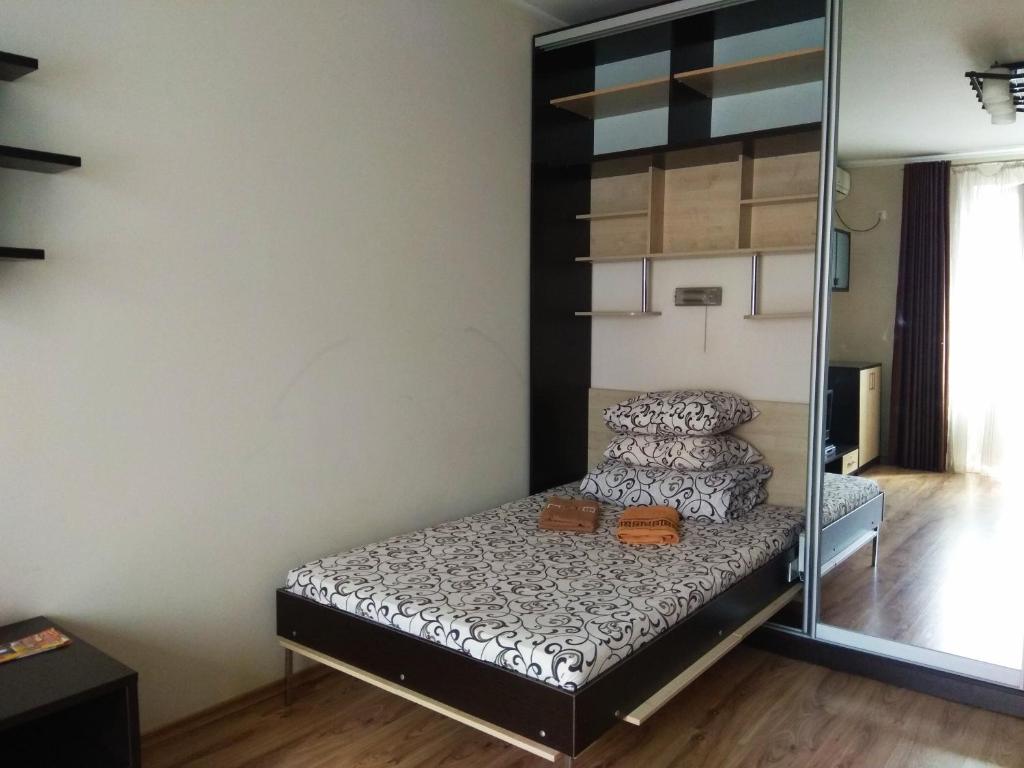 a small bedroom with a bunk bed and a mirror at Apartment on Sobornaya street in Rivne