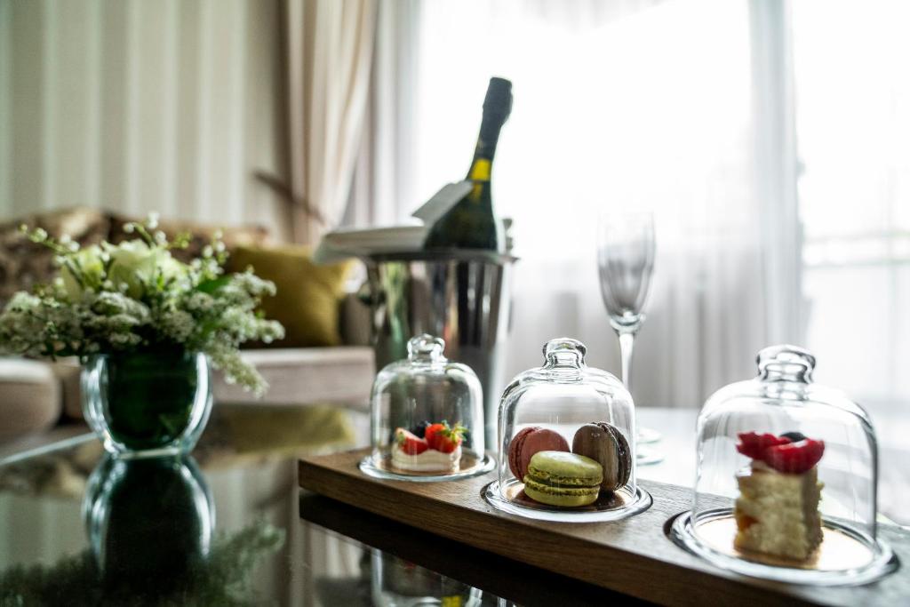 a table with two plates of food in glass jars at Baltic Beach Hotel & SPA in Jūrmala